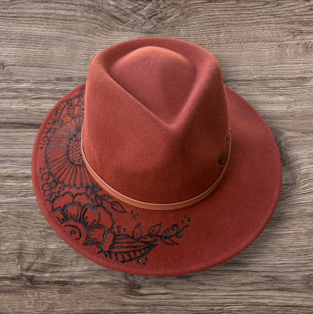 Terracotta Fedora-100% wool. Burnt Flowers with ‘A flower blossoms for its own joy’ quote underneath brim.