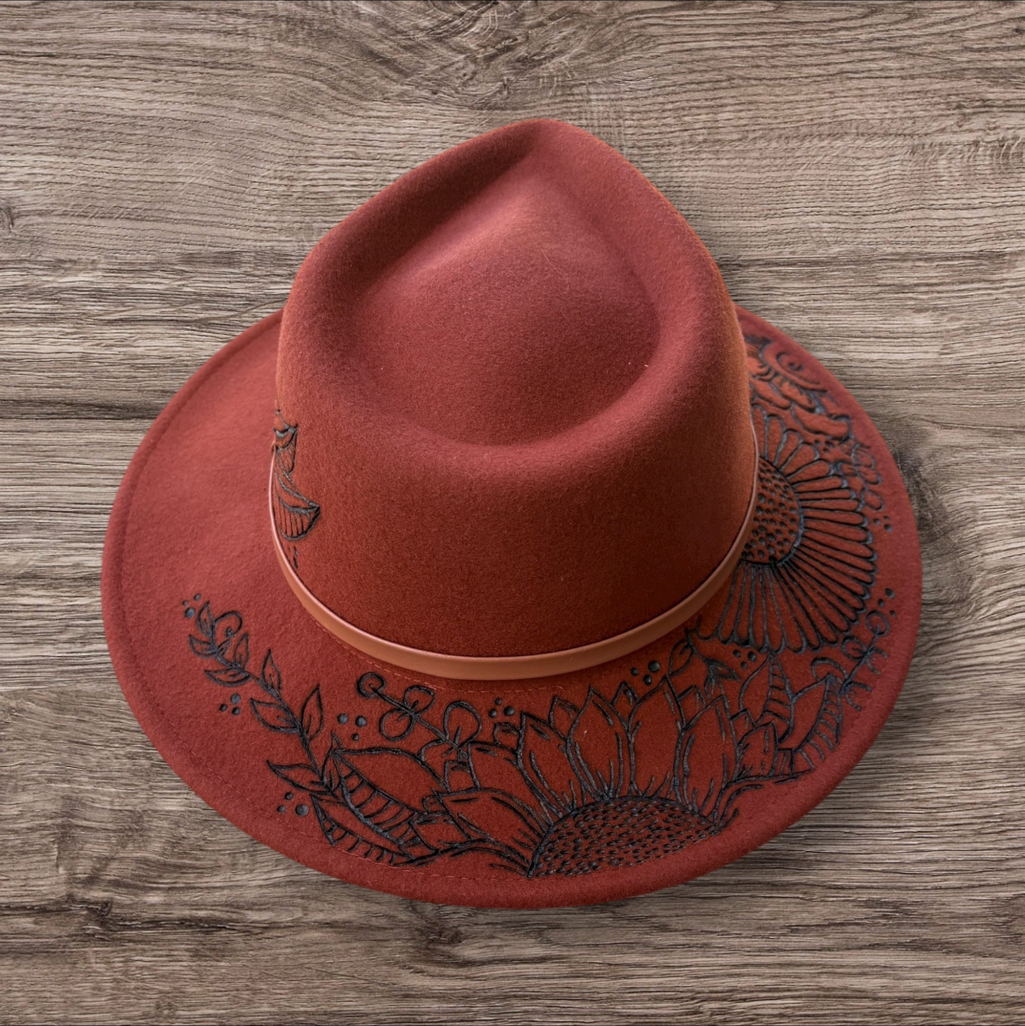Terracotta Fedora-100% wool. Burnt Flowers with ‘A flower blossoms for its own joy’ quote underneath brim.