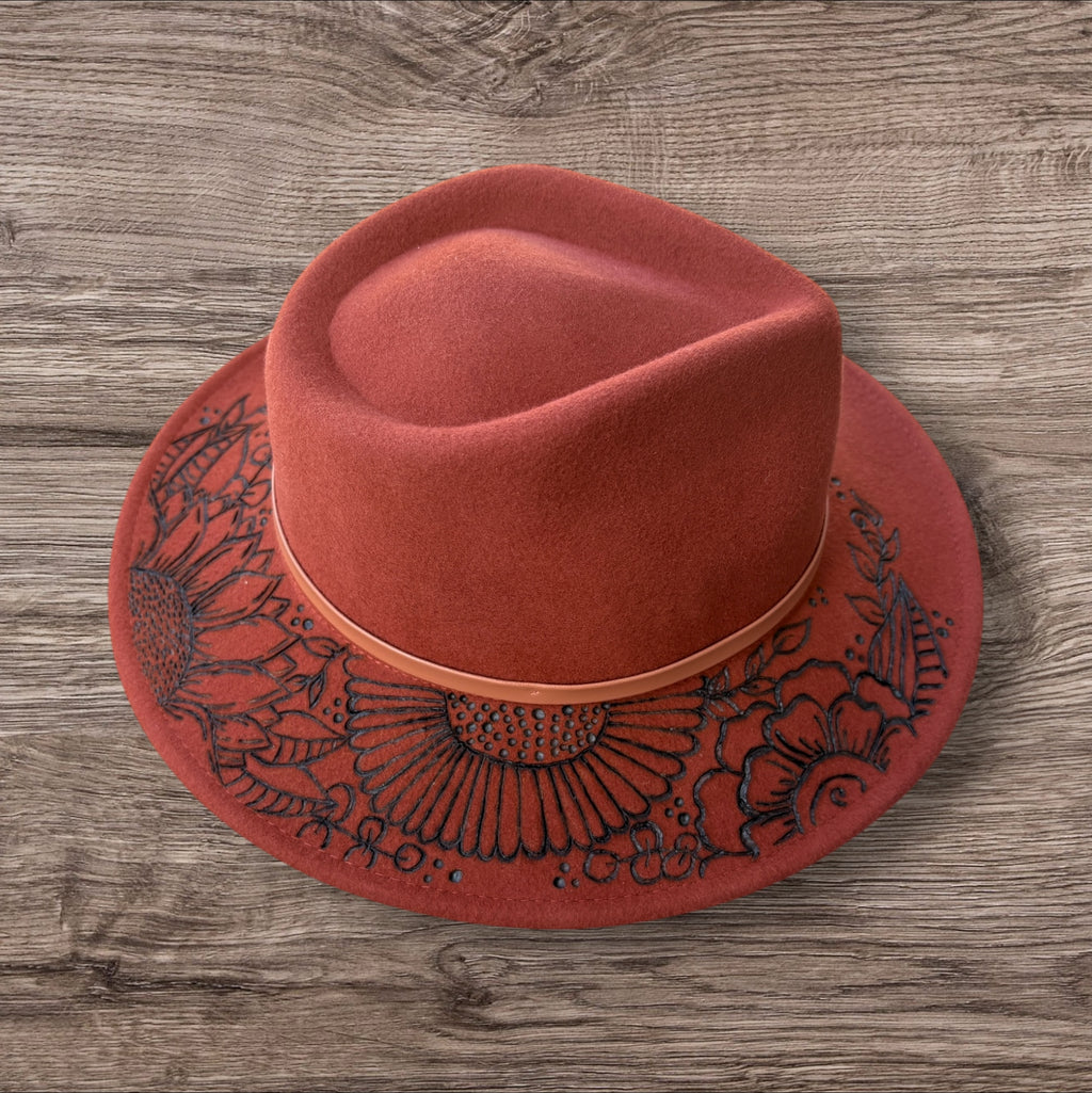 Terracotta Fedora-100% wool. Burnt Flowers with ‘A flower blossoms for its own joy’ quote underneath brim.