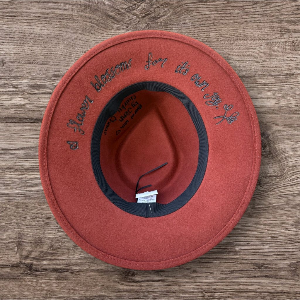 Terracotta Fedora-100% wool. Burnt Flowers with ‘A flower blossoms for its own joy’ quote underneath brim.