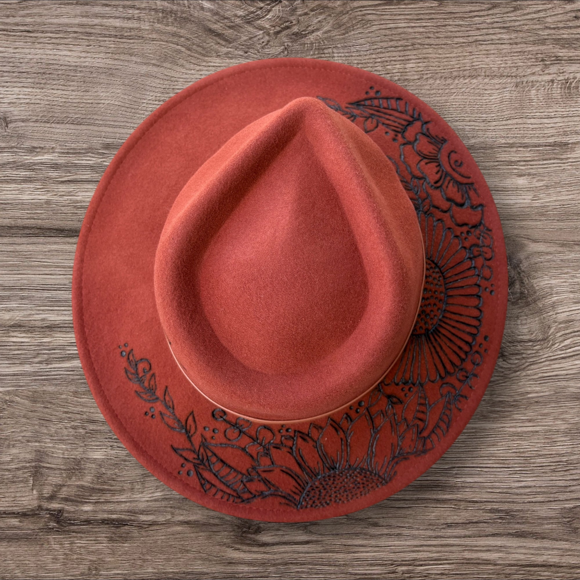 Terracotta Fedora-100% wool. Burnt Flowers with ‘A flower blossoms for its own joy’ quote underneath brim.
